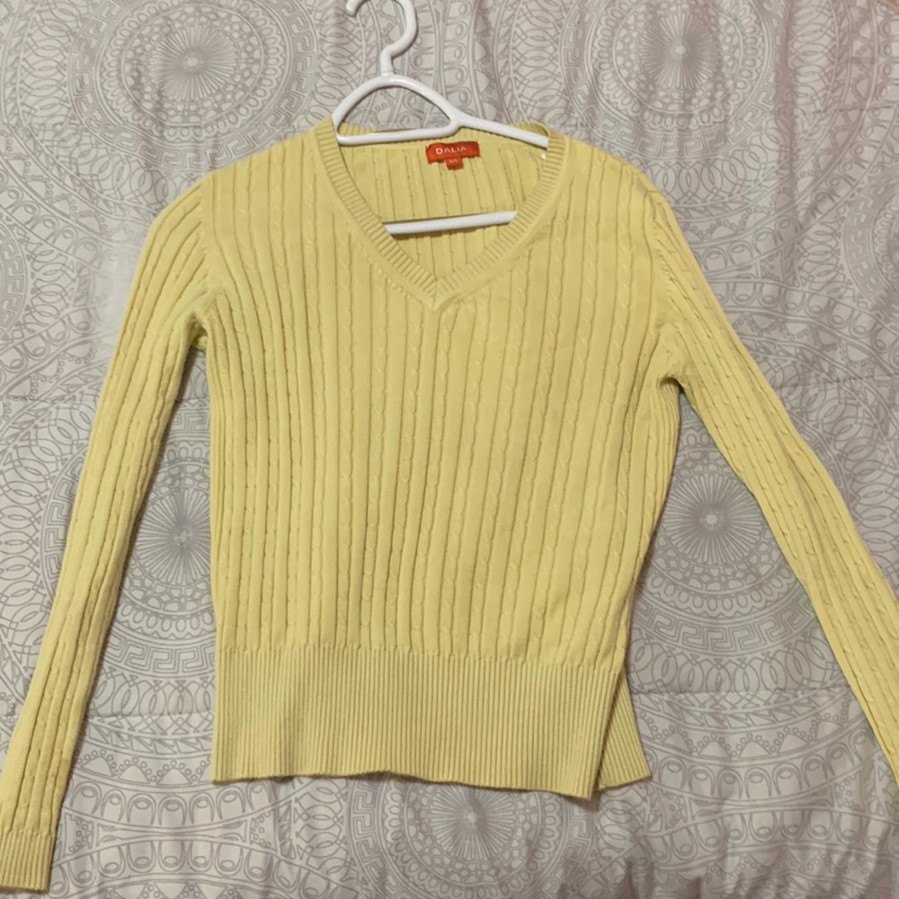 A yellow v- neck sweater. Brand is Daila and came large but shrunk to medium.